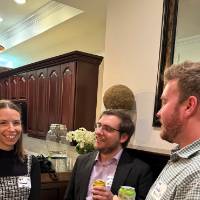 Three DC alumni talking together.